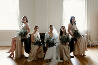 bridesmaids in satin dresses with bride