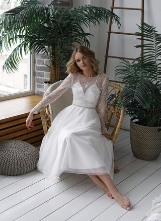 model in a short wedding dress with sleeves